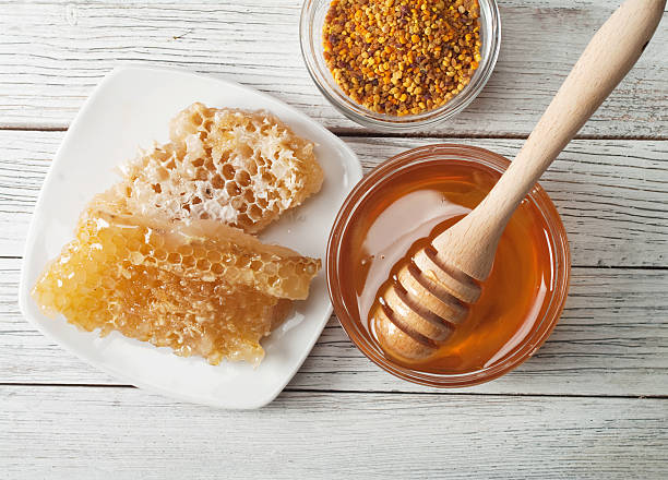 Still life with honey, honeycomb, pollen